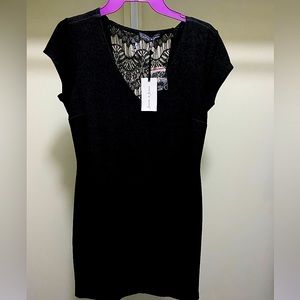 Classic tapered black dress with peek-a-boo black lace on back.